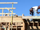 A construction worker uses a hammer at a new housing development in San Mateo, California.