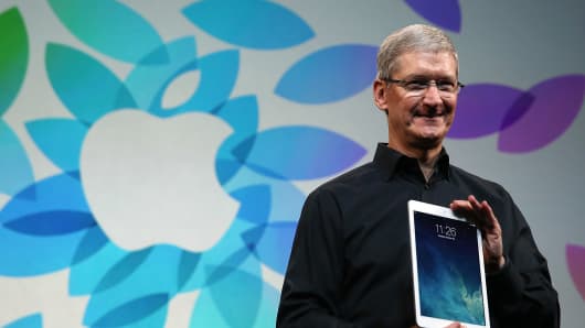 Apple CEO Tim Cook holds the new iPad Air during an Apple announcement at the Yerba Buena Center for the Arts on October 22, 2013 in San Francisco.