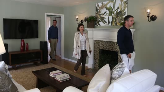 Real estate agents tour a home for sale during an open house in San Anselmo, Calif.