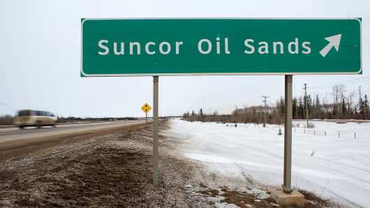 A sign directing traffic to the Suncor Oil Sands, north of Fort McMurray, Alberta, Canada.
