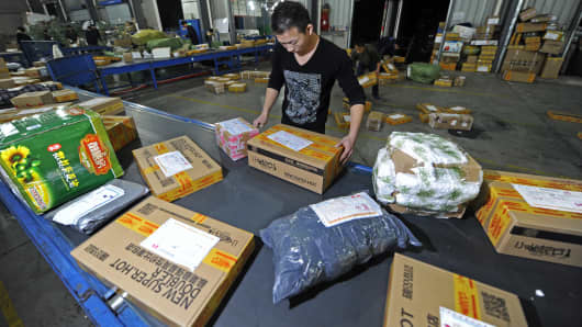 Workers distribute packs at an express company on November 12, 2012 in Wuhan, China.