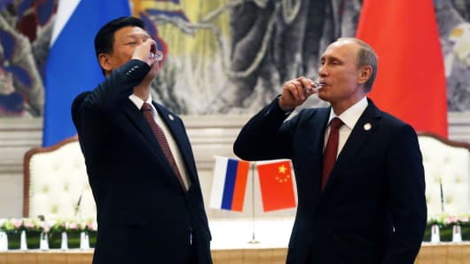 Russian President Vladimir Putin and Chinese President Xi Jinping toast during a signing ceremony on May 21, 2014, in Shanghai.