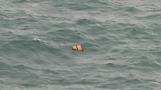 This aerial view taken from an Indonesian search and rescue aircraft over the Java Sea shows floating debris spotted in the same area as other items being investigated by Indonesian authorities as possible objects from missing AirAsia flight QZ8501 on December 30, 2014.