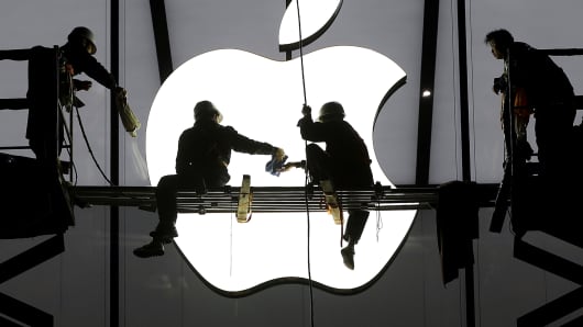 Workers prepare for the opening of an Apple store in China.
