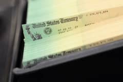 In this photo illustration U.S. Treasury checks are piled at the U.S. Treasury printing facility July 18, 2011 in Philadelphia, Pennsylvania.