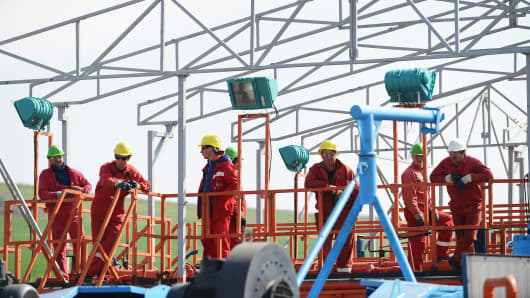 Employees during a press visit to the first shale gas exploring site started by Chevron in Pungesti, Romania, April 2014.