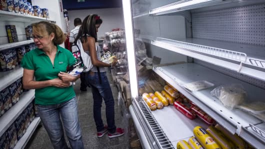 Women shop at a private-sector grocery store in Caracas, Venezuela in February.