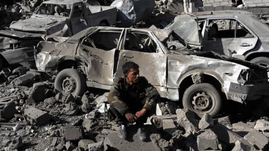 Yemeni men search for survivors in rubble of buildings after airstrikes of a 10-member coalition of Gulf countries in Yemeni capital Sanaa.