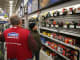 An employee helps a customer shop for a sander at a Lowe's home improvement store in Chicago.