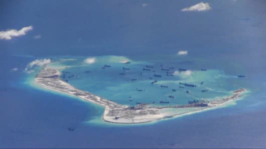 Chinese dredging vessels are purportedly seen in the waters around Mischief Reef in the disputed Spratly Islands in the South China Sea in this still image from video taken by a P-8A Poseidon surveillance aircraft provided by the United States Navy May 21, 2015.