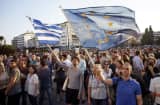 Pro-European Union protesters take part in a rally in front of the parliament on June 18, 2015 in Athens, Greece.