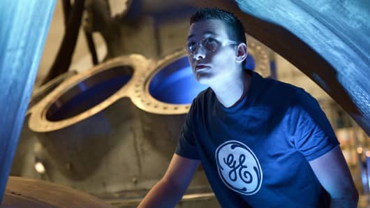 A worker looks at the 9HA Gas Turbine, at the General Electric plant in Belfort, France.