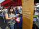 A woman gets information from the Blue Shield of California booth at the East Los Angeles Health Fair held at Griffith Middle School on September 21, 2013 in East Los Angeles.