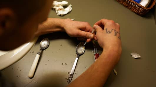 Drugs are prepared to be used intravenously by a user addicted to heroin in St. Johnsbury, Vermont.