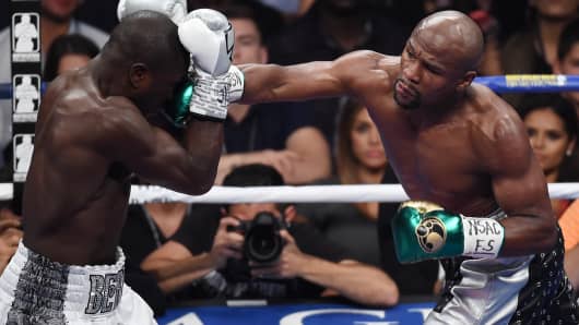 Floyd Mayweather Jr. throws a right at Andre Berto during their WBC/WBA welterweight title fight at MGM Grand Garden Arena on September 12, 2015 in Las Vegas, Nevada.