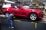 A General Motors worker puts the finishing touches on a new 2016 Chevrolet Camaro at the Lansing Grand River Assembly Plant October 26, 2015 in Lansing, Michigan.