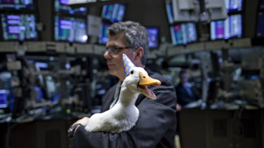Todd Evans, animal handler with Dawn Animal Agency, holds the Aflac Duck on the floor of the New York Stock Exchange in New York.