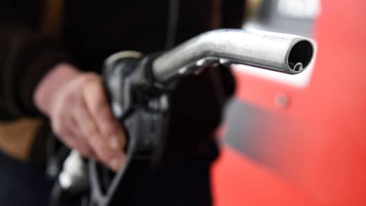 A man prepares to put fuel in his van at a filling station.