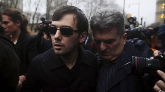 Martin Shkreli (C), chief executive officer of Turing Pharmaceuticals and KaloBios Pharmaceuticals Inc, departs U.S. Federal Court after an arraignment following his being charged in a federal indictment filed in Brooklyn relating to his management of hedge fund MSMB Capital Management and biopharmaceutical company Retrophin Inc. in New York