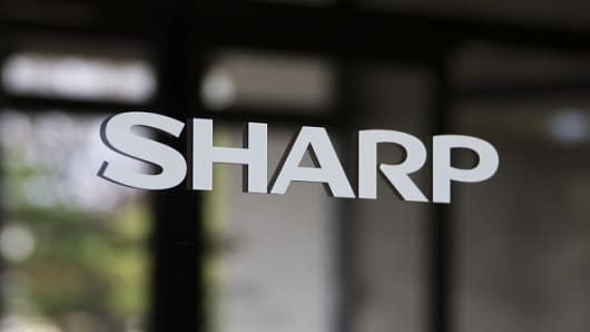 A Sharp Corp. logo is displayed on a door at the entrance to the company's plant in Yaita, Tochigi Prefecture, Japan, on Thursday, Nov. 19, 2015.