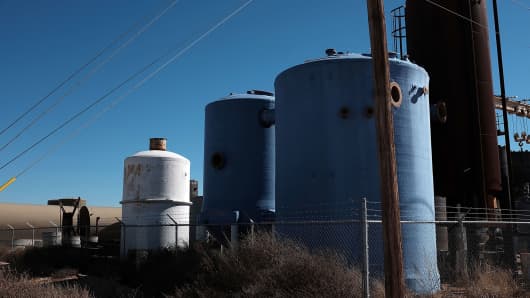 Unused tanks for the oil industry pile-up in a shop yard in the Permian Basin oil field on January 20, 2016 in the oil town of Andrews, Texas.