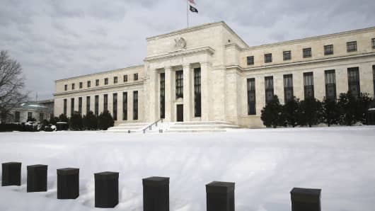 Snow covers the grounds of the U.S. Federal Reserve in Washington January 26, 2016.