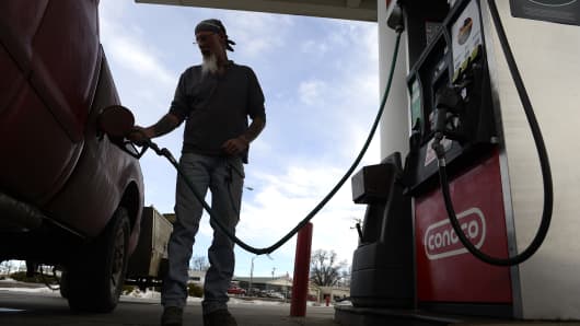 A man fills his truck up with gas at a gas station on January 25, 2016 in Kersey, Colorado. 