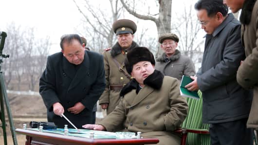 North Korean leader Kim Jong Un gives instruction during a simulated test of atmospheric re-entry of a ballistic missile, at an unidentified location in this undated photo released by North Korea's Korean Central News Agency (KCNA) in Pyongyang on March 15, 2016.