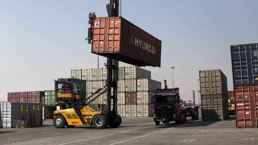 A crane loads a shipping container onto a truck at Shahid Rajaee port, some 20 kms west of Gulf port city of Bandar Abbas on February 21, 2016.