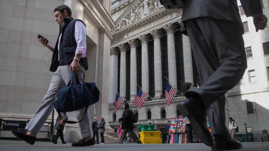 Pedestrians walk past the New York Stock Exchange (NYSE) in New York.