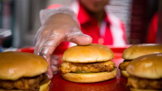 Chick-fil-A employees prepare chicken sandwiches for guests