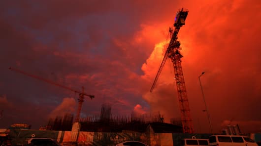 Cranes stand still at sunset in October 2015, on the site of a new, Chinese-built hotel in Colombo. A new Sri Lankan government suspended support for a number of Chinese projects in 2015, including the capital's Port City mega-development.