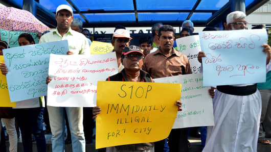 Activists demonstrate in Colombo in March 2015 over the $1.4B Chinese-funded Port City project, which began construction in 2014 despite claims of the sea reclamation process would cause environmental damage.