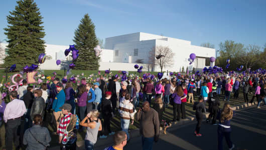 Music fans visit a memorial outside Paisley Park, the home and studio of Prince, on April 22, 2016 in Chanhassen, Minnesota.