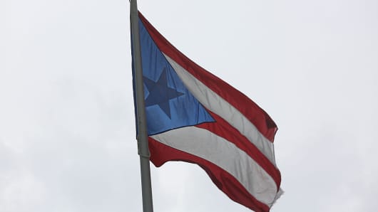The Puerto Rican flag flies near the Capitol building. US Treasury Secretary Jack Lew warned on Monday that time was running out to address the spiraling crisis in Puerto Rico a week after the island suffered a dramatic default.