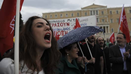 Protesters shout slogans during a demonstration against a new package of tax hikes and reforms in front of the parliament building in Athens, Greece, May 22, 2016. [Michalis Karagiannis | Reuters]