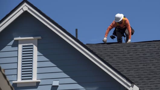 A worker attaches roofing to a house under construction at the KB Home Magnolia at Patterson Ranch community in Fremont, California, June 20, 2016.