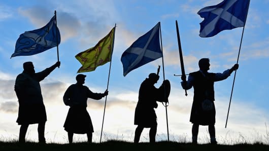 Duncan Thomson, Brian McCutcheon, John Patterson and Arthur Murdoch,from King of Scots Robert the Bruce Society, hold the Scottish flags as they prepare to vote in the Scottish independence referendum on September 14, 2014 in Loch Lomond.