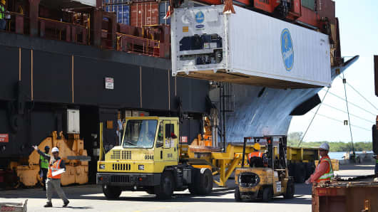 Shipping containers are offloaded from a cargo ship at Port Everglades on June 24, 2016 in Fort Lauderdale, Florida.
