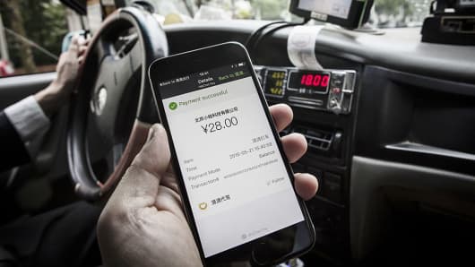 The payment confirmation page is displayed on the Didi Chuxing application in this arranged photograph taken in Shanghai, China, on Sunday, May 22, 2016.