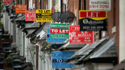 An array of To Let and For Sale signs protrude from houses in the Selly Oak area of Birmingham, UK