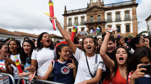 Youngsters gather to celebrate the arrival of the Olympic torch at Tiradentes Square in Ouro Preto, Minas Gerais, Brazil last May.