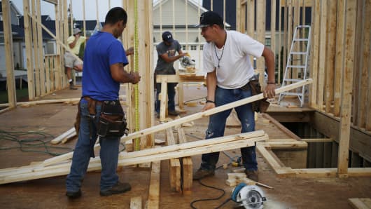Contractors work on the wood framing for a house under construction in the Norton Commons subdivision of Louisville, Kentucky, U.S., on Friday, July 29, 2016.