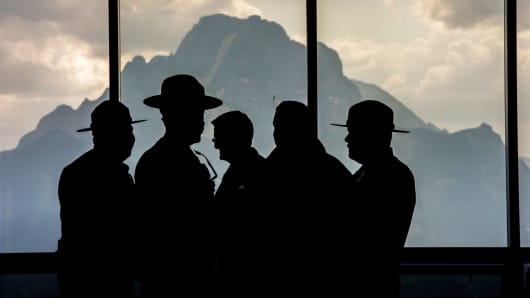 National Park Rangers stand silhouetted inside the lobby of Jackson Lake Lodge during the Jackson Hole economic symposium, sponsored by the Federal Reserve Bank of Kansas City, in Moran, Wyoming, last August.