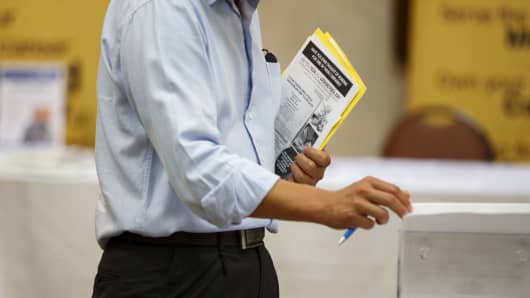 A job seeker looks at brochures during a Choice Career Fair in Los Angeles.