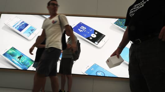 Customers shop at a new Apple store on August 16, 2016 in New York City.