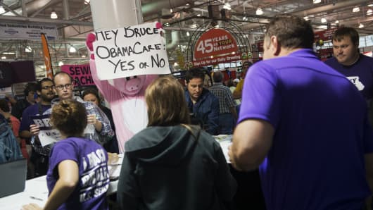 A heckler holds a sign taunting Senate candidate Rep. Bruce Braley, D-Iowa, about the Affordable Care Act at the 2014 Iowa State Fair in Des Moines, Iowa, August 7, 2014.