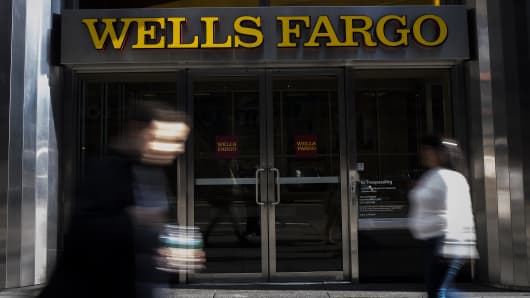 Pedestrians walk past a Wells Fargo & Co. bank branch in New York, U.S., on Thursday, Oct. 6, 2016.