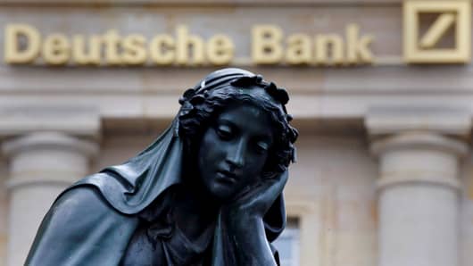 2016A statue is seen next to the logo of Germany's Deutsche Bank in Frankfurt, Germany.