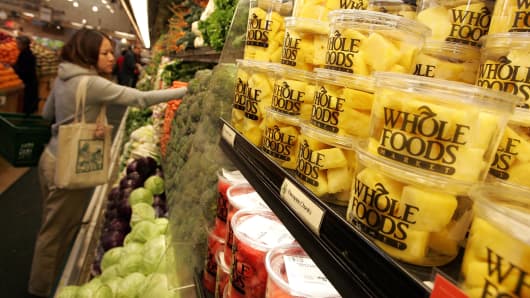 A customer shops for produce at a Whole Foods Market.